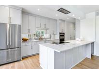 Modern kitchen with stainless steel appliances, marble countertops, and light wood flooring at 2575 Peachtree Ne Rd # 6G, Atlanta, GA 30305