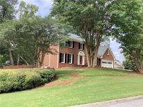 Traditional two-story brick home with black shutters and mature landscaping at 3243 Northbrook Dr, Atlanta, GA 30341