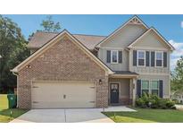 Two-story home with a brick and siding exterior, a two-car garage, and a well-maintained lawn at 4172 Cedar Commons Way, Conley, GA 30288