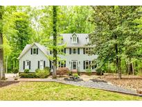 Traditional two-story home with black shutters, mature trees, manicured lawn, and meticulous landscaping at 120 Majesty Ln, Fayetteville, GA 30215