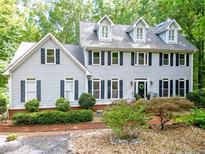 Charming two-story home featuring a landscaped yard, dormer windows, and a welcoming front entrance at 120 Majesty Ln, Fayetteville, GA 30215