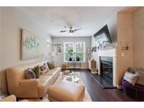 Cozy living room featuring a fireplace, ceiling fan, hardwood floors and an attractive area rug at 3150 Woodwalk Se Dr # 2204, Atlanta, GA 30339