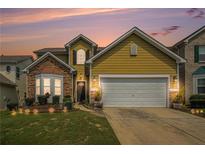 Charming home features a two-car garage, manicured lawn, and beautiful landscaping at 7761 Parkside Dr, Lithia Springs, GA 30122
