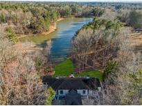 Breathtaking aerial view of the home and its serene waterfront location along the winding lake at 1126 Wedgefield Sw Dr, Marietta, GA 30064