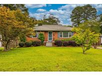 Charming brick home with manicured lawn, shrubbery, and inviting front entrance at 2191 Fairfield Se St, Smyrna, GA 30080