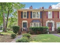 Charming brick townhouse with well-manicured lawn and tidy landscaping with brick exterior at 967 Chippendale Ln, Norcross, GA 30093