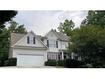 Traditional two-story home featuring a two-car garage, stone accents, and neatly trimmed landscaping at 107 Sedgefield Overlook, Dallas, GA 30157