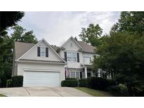 Traditional two-story home with an attached garage, manicured lawn, and classic architectural details at 107 Sedgefield Overlook, Dallas, GA 30157