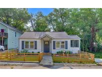 Charming home featuring a cozy front porch and fenced yard at 845 Oak Nw St, Atlanta, GA 30318