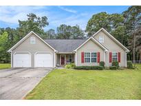Charming single-story home with a two-car garage, well-maintained lawn, and lovely landscaping at 169 Winding Valley Dr, Rockmart, GA 30153