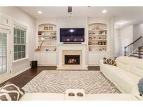 Inviting living room with a cozy fireplace, custom built-ins, and a comfortable seating area at 1896 Grove Field Ln # 29, Marietta, GA 30064