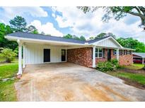 Charming brick home featuring a covered carport, adding convenience and curb appeal at 6213 Cherry Ln, Douglasville, GA 30134