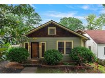 Charming craftsman-style home with a well-maintained lawn and lush landscaping at 628 Home Se Ave, Atlanta, GA 30312