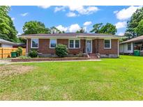 Charming brick ranch with a well-manicured lawn and inviting front entrance at 821 Springvalley Dr, Forest Park, GA 30297