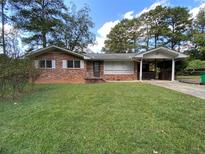 Charming brick home with a well-maintained lawn and a convenient covered carport at 3098 Henderson Mill Rd, Atlanta, GA 30341