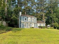Charming two-story home with a well-maintained lawn, white trim, and mature trees at 354 Dublin Way, Lawrenceville, GA 30044