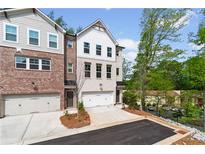 Newly constructed townhome with a one-car garage and professionally landscaped front yard at 586 Avondale Park Cir, Decatur, GA 30032