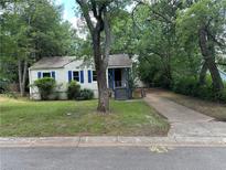 Charming single-story home featuring a well-maintained front yard and a cozy front porch at 1897 E Hazelwood Se Dr, Marietta, GA 30067