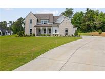 Stunning two-story home featuring a manicured lawn, elegant brickwork, and a long driveway at 158 Palisade Dr, Rydal, GA 30171