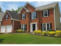Traditional two-story brick home with a well-manicured lawn and black shutters at 1713 Paramore Ne, Marietta, GA 30062