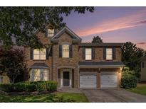 Charming two-story home with a stone facade, a two-car garage, and professionally landscaped front yard at 3533 Aberdeen Way, Douglasville, GA 30135