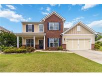 Charming two-story home featuring a well-manicured lawn and inviting curb appeal at 441 Spring View Dr, Woodstock, GA 30188