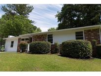 Charming single-story brick home with well-maintained lawn and mature landscaping at 70 Ruzelle Se Dr, Atlanta, GA 30354