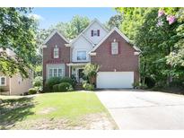 Charming brick home with a well-manicured lawn and attached two-car garage at 1441 Hada Ln, Lawrenceville, GA 30043