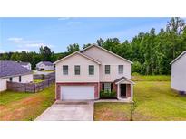 Inviting two-story home with a brick-accented facade and attached two-car garage at 510 Abeer St, Temple, GA 30179