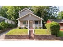 Charming two-story home with landscaped front yard and inviting front porch, perfect for relaxing outdoors at 996 Palmetto Sw Ave, Atlanta, GA 30314