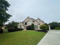 Stately two-story brick home with manicured lawn and mature landscaping at 2609 Jacobs Crest Cv, Grayson, GA 30017