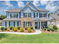 Charming two-story home with stone accents, manicured lawn, and classic curb appeal at 2953 Balvenie Pl, Acworth, GA 30101