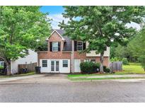 Charming two-story home with a brick facade and a lush green yard at 433 Pearl St, Locust Grove, GA 30248