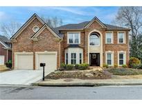 Beautiful two-story brick home with a two-car garage and well-maintained landscaping at 2730 Henderson Chase Ct, Tucker, GA 30084