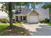 Charming single-Gathering home features a one-car garage and a cozy front porch with mature trees at 163 Silver Fox Trail Trl, Dallas, GA 30157