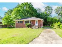 Charming brick home featuring a well-maintained lawn and a classic single-story design at 1167 Sanders Dr, Morrow, GA 30260