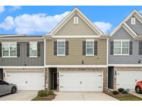 Charming townhome with a one-car garage and well-maintained landscaping at 11689 Mendenhall Ct, Hampton, GA 30228