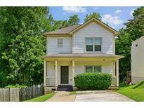 Charming two-story home with a covered front porch and fresh landscaping at 55 Bowen Ave, Atlanta, GA 30315