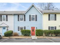 Charming townhome with colorful exterior, well-maintained landscaping, and convenient parking at 2859 Spring Villa Se Ln, Smyrna, GA 30080