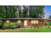 Charming brick home with well-maintained lawn and mature trees offering a serene setting at 1630 Park Ln, Marietta, GA 30066