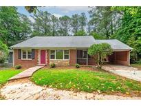 Charming brick home with a well-maintained lawn, updated walkway and a convenient carport at 3080 Lynhurst Cir, Atlanta, GA 30311