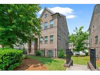 Well maintained townhouse with manicured landscaping and black metal fence surrounding the property at 1463 Edgebrook Ne Ct # 14, Atlanta, GA 30329