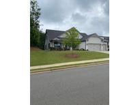 Traditional style home with a well maintained lawn, paved driveway and attached two car garage at 203 Belmont Park Dr, Canton, GA 30115