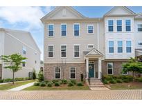 Charming townhouse featuring a brick facade, inviting entrance, and meticulously manicured landscaping at 361 Watson Ave, Woodstock, GA 30189