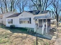 Charming bungalow-style home with a quaint screened-in front porch and mature trees at 1386 Bluefield Sw Dr, Atlanta, GA 30310
