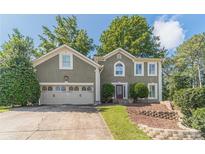 Charming two-story home featuring a well-manicured lawn, two-car garage, and a welcoming front entrance at 3830 Gallant Fox Ct, Duluth, GA 30096