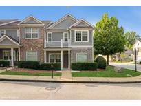 Charming townhome with stone accents, gray siding and a well-manicured lawn at 5612 Festival Ave, Fairburn, GA 30213
