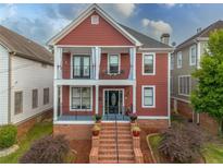 Charming two-story home featuring double balconies, brick stairs, and a professionally landscaped front yard at 121 Fulton Se Way, Atlanta, GA 30312