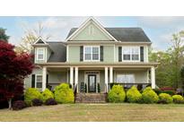 Charming two-story home featuring a welcoming front porch and well-manicured landscaping at 109 Lighthorse Blvd, Mcdonough, GA 30252