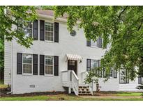 Charming two-story home with white painted brick, black shutters and awning over the front door at 2201 Logan Dr, Jonesboro, GA 30236